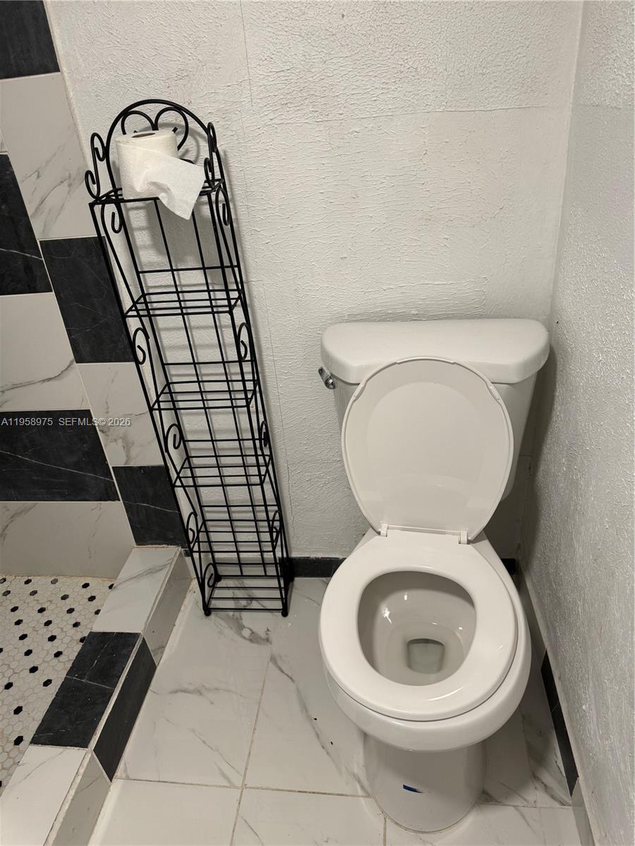 1822 Cleveland Street, Unit 3 Hollywood, FL 33020 - Photo 4 of 35 a bathroom with a toilet and a sink