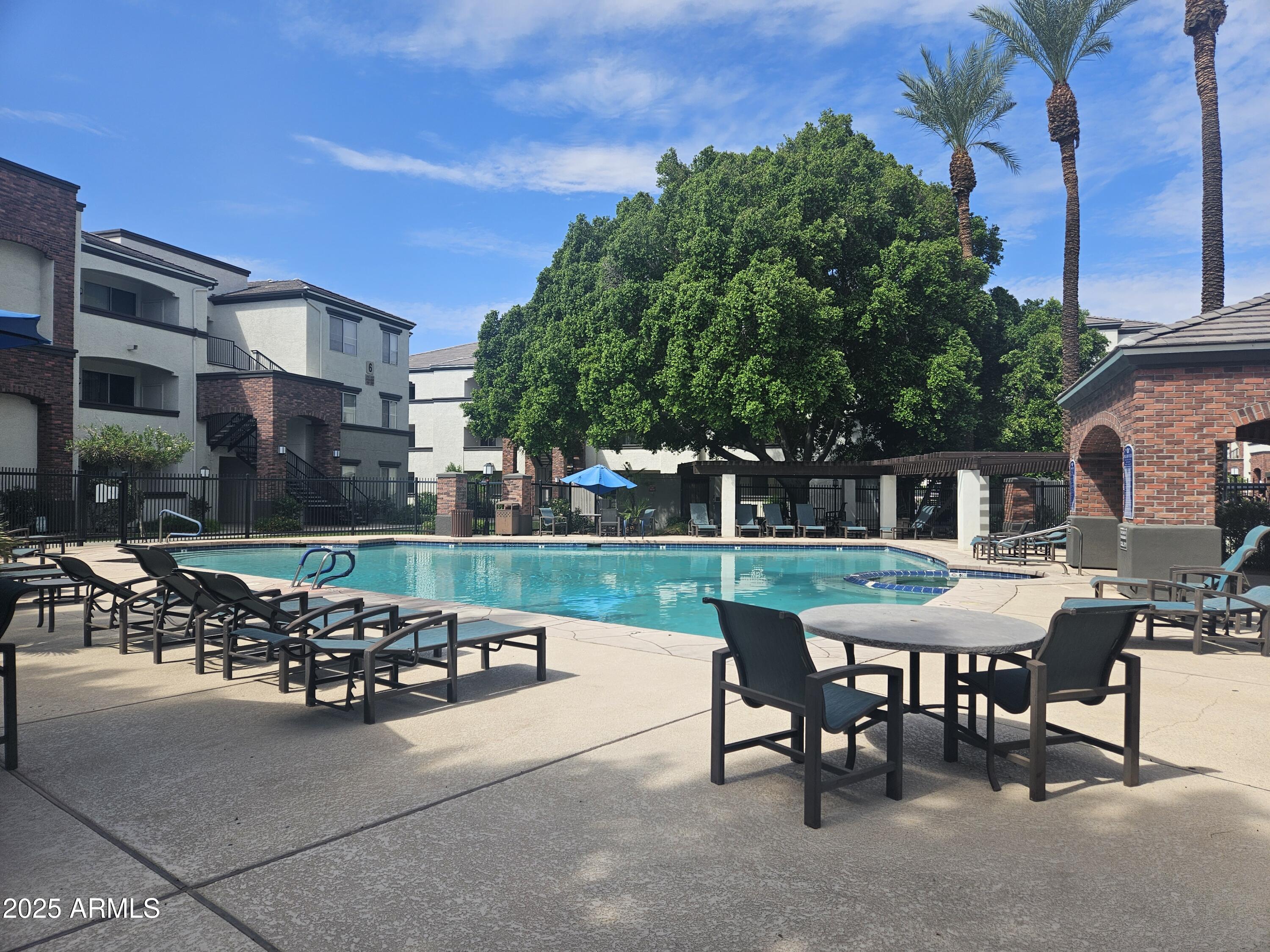 a view of a patio with a table and chairs