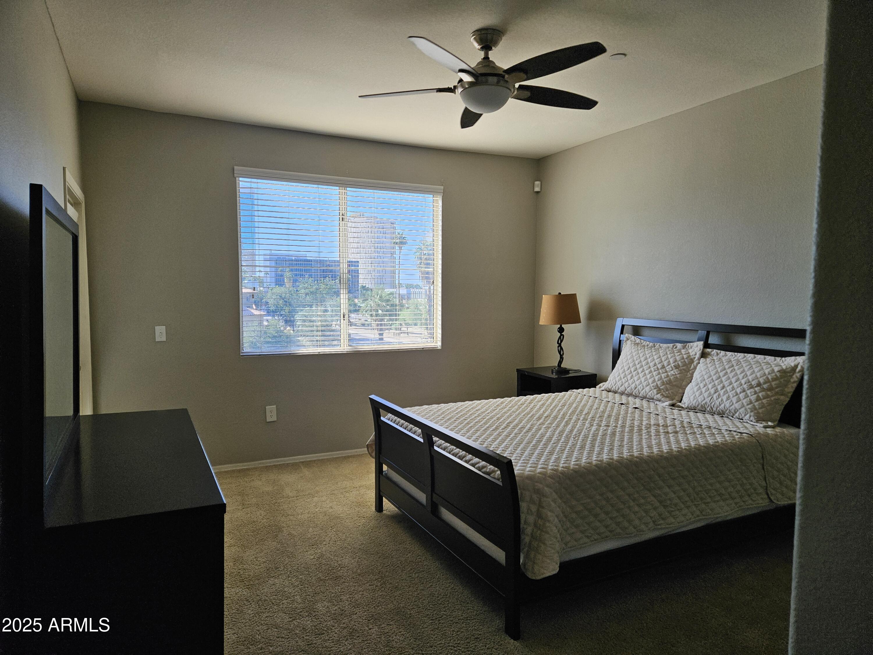 3302 North 7th Street, Unit 332 Phoenix, AZ 85014 - Photo 12 of 33 a bedroom with a bed and a painting on the wall