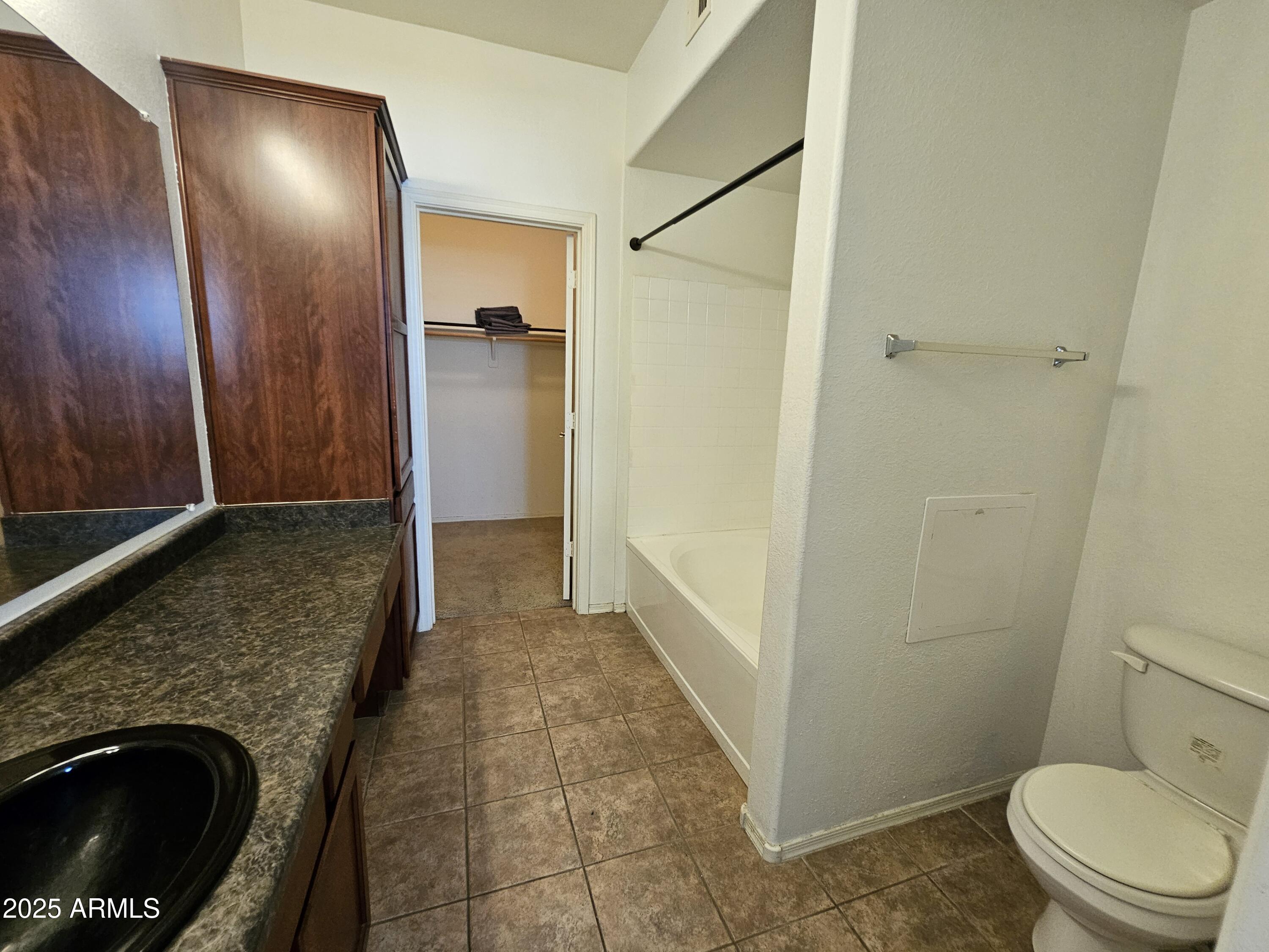3302 North 7th Street, Unit 332 Phoenix, AZ 85014 - Photo 14 of 33 a bathroom with a granite countertop shower and a toilet