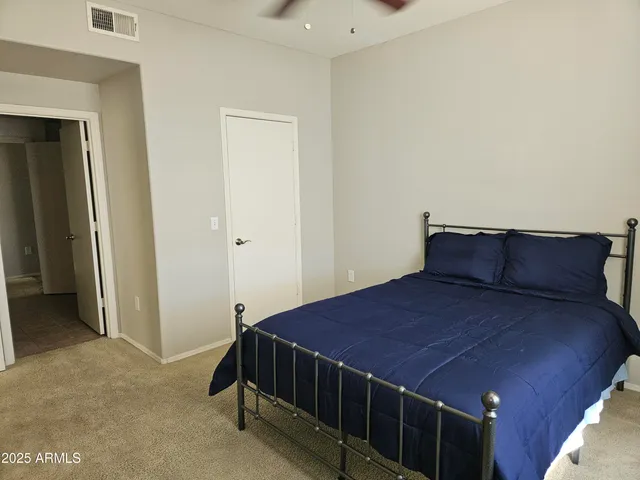 a bedroom with a bed and window