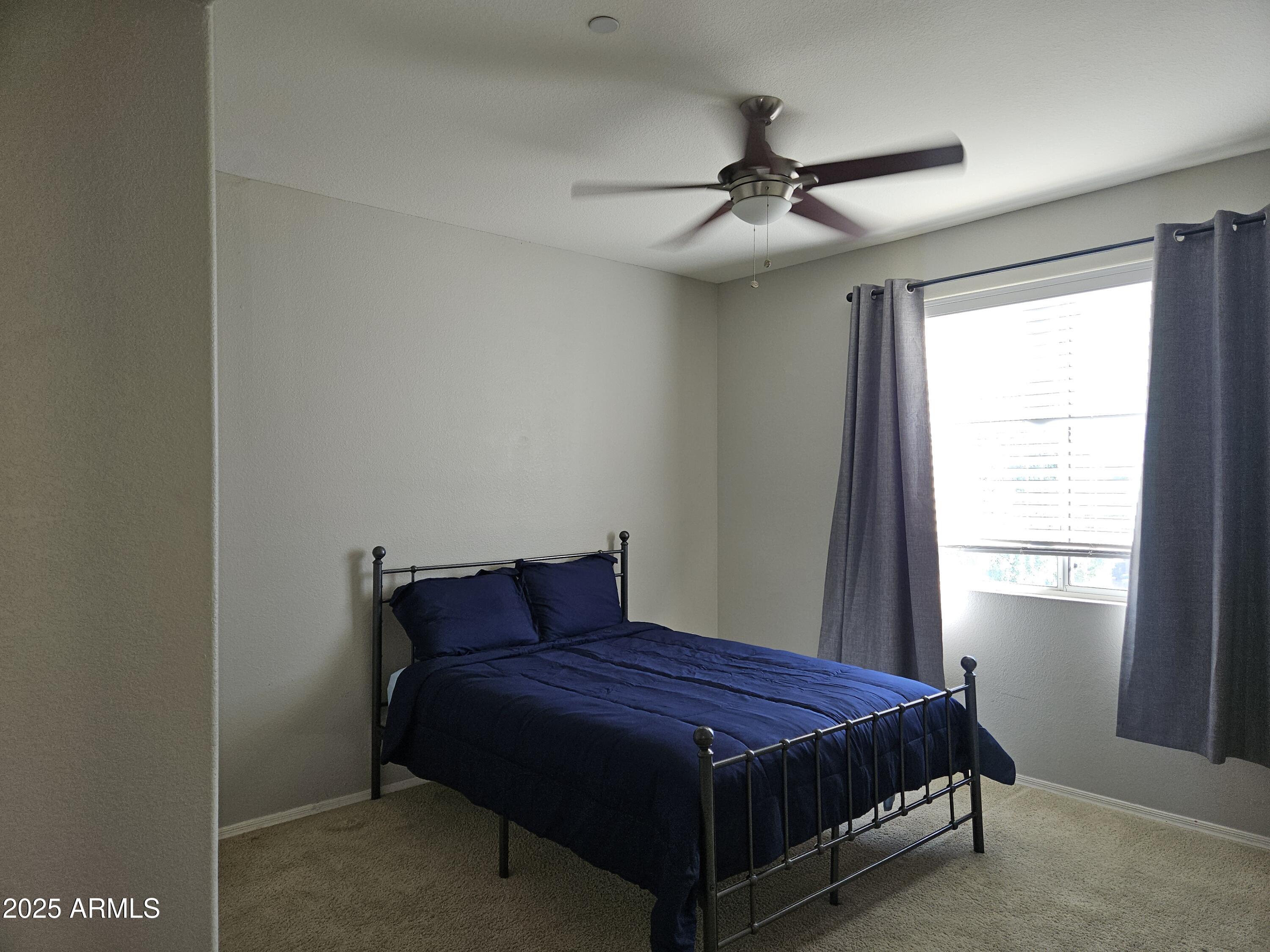 3302 North 7th Street, Unit 332 Phoenix, AZ 85014 - Photo 18 of 33 a bedroom with a bed and window