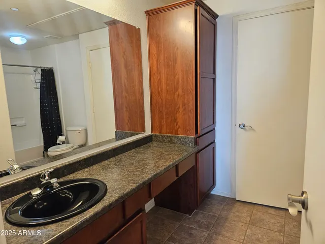 a bathroom with a toilet and a shower curtain