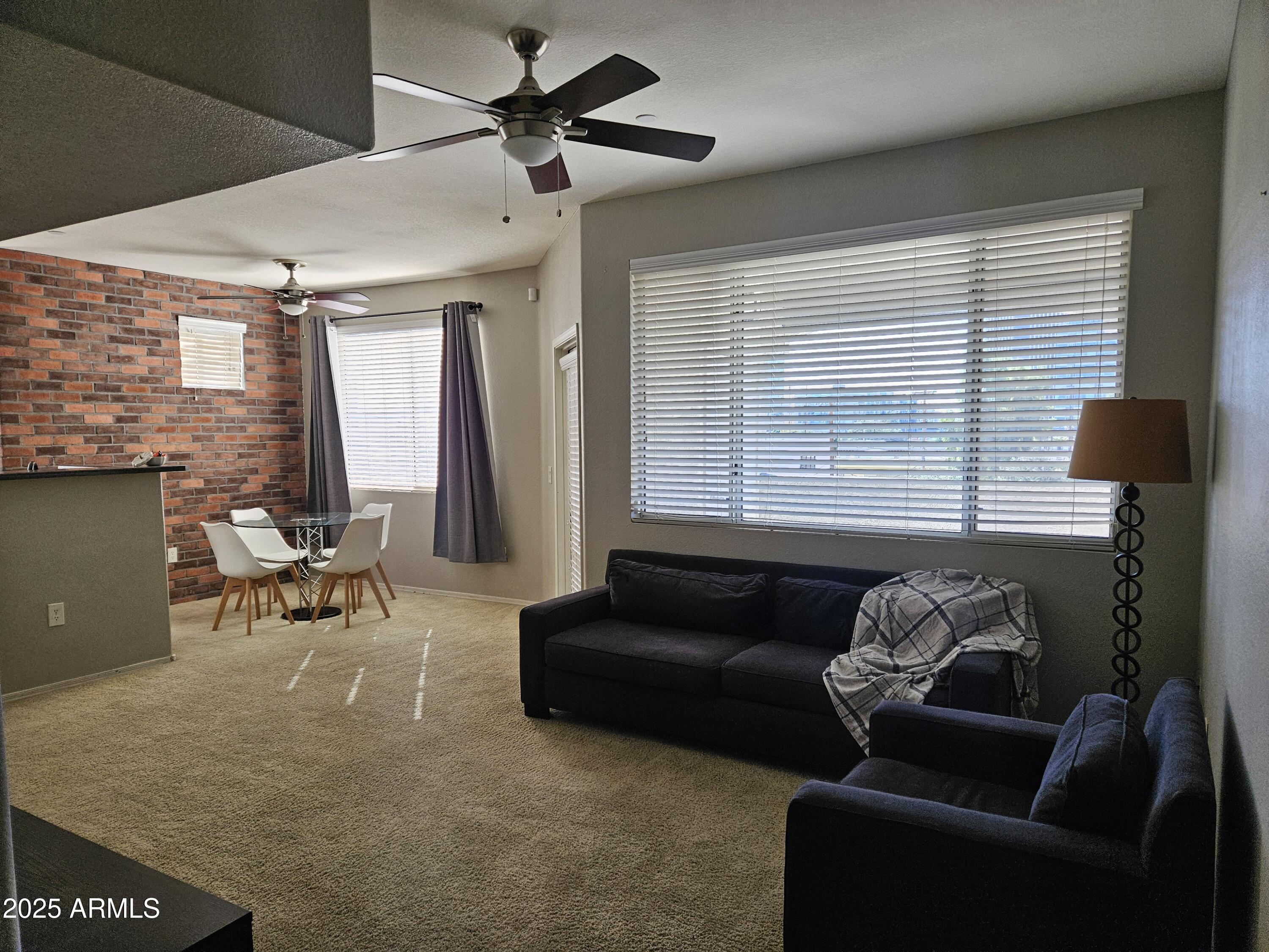 3302 North 7th Street, Unit 332 Phoenix, AZ 85014 - Photo 2 of 33 a living room with furniture and large windows