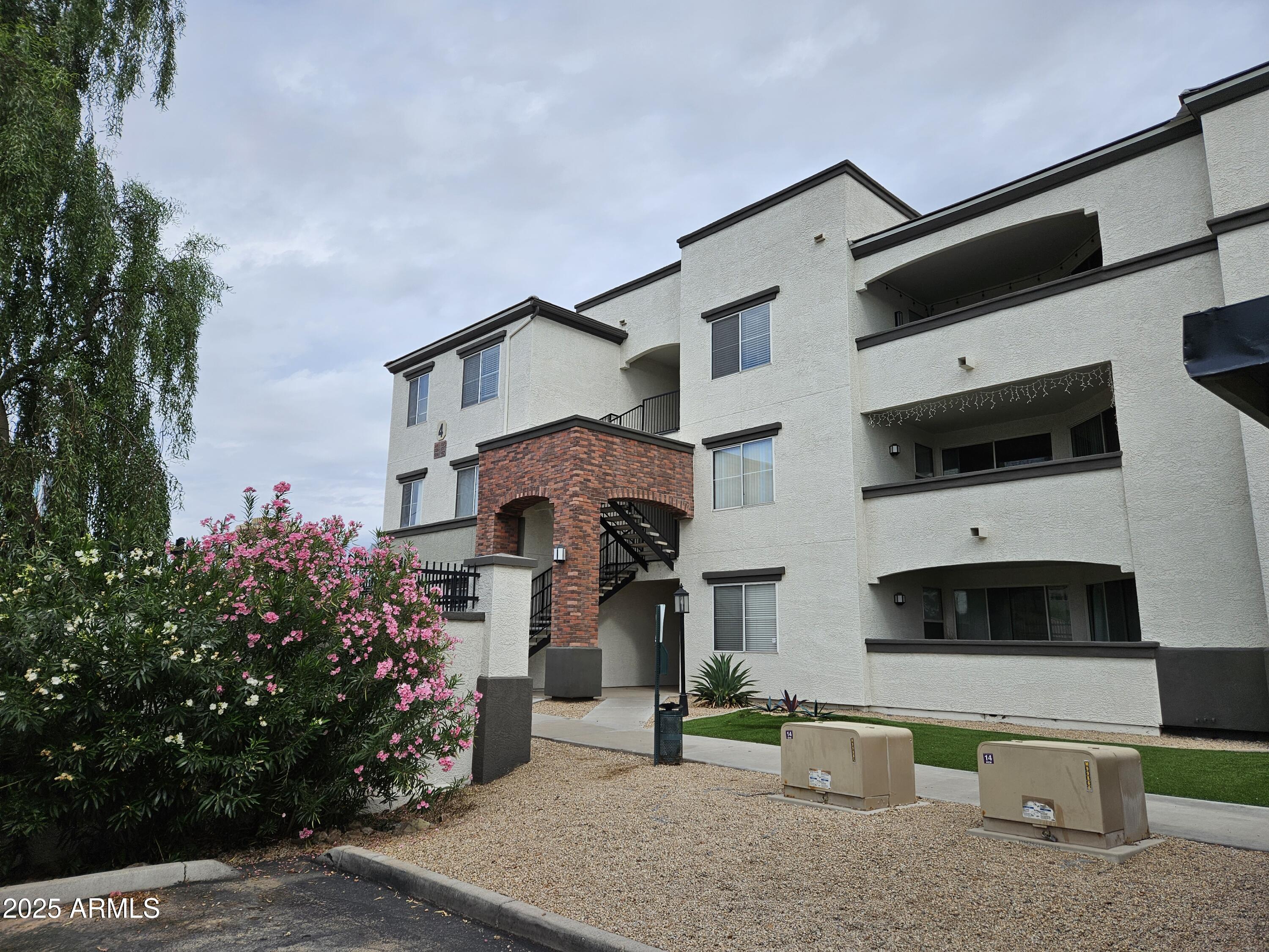 3302 North 7th Street, Unit 332 Phoenix, AZ 85014 - Photo 32 of 33 a front view of a house with a yard