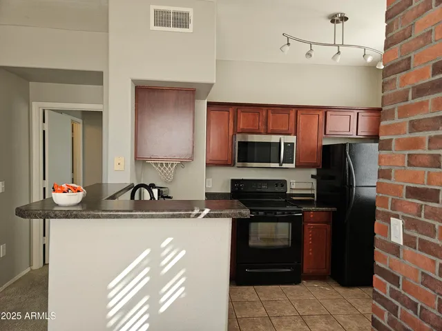 a kitchen with stainless steel appliances a sink stove and microwave