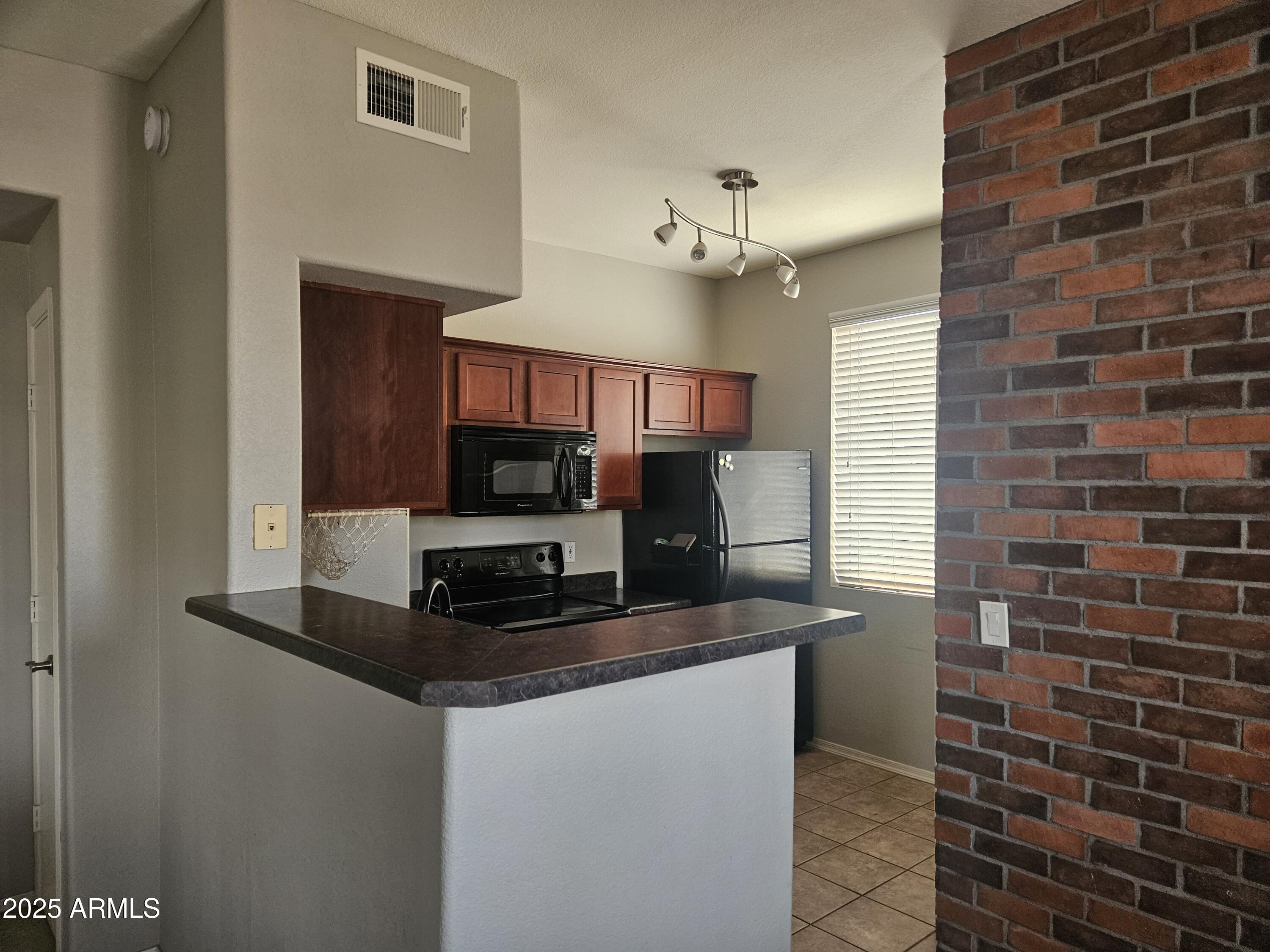 3302 North 7th Street, Unit 332 Phoenix, AZ 85014 - Photo 7 of 33 a kitchen with stainless steel appliances a sink stove and microwave