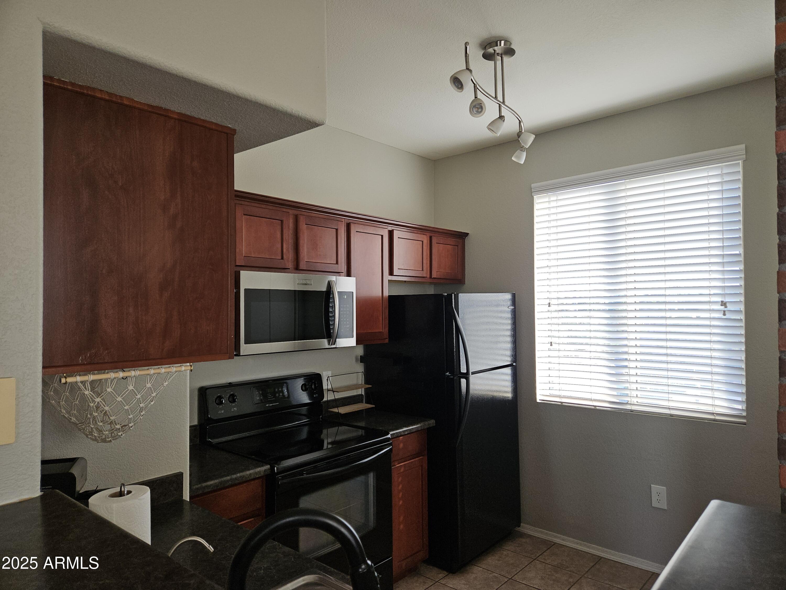 3302 North 7th Street, Unit 332 Phoenix, AZ 85014 - Photo 8 of 33 a kitchen with a refrigerator a stove a sink and a window