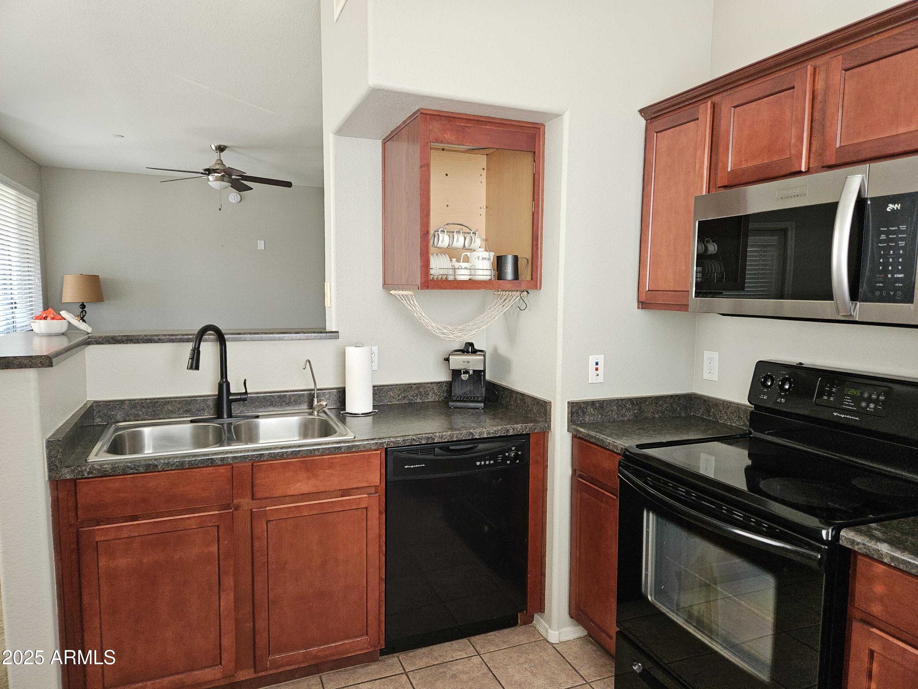 3302 North 7th Street, Unit 332 Phoenix, AZ 85014 - Photo 9 of 33 a kitchen with stainless steel appliances granite countertop a sink stove and microwave