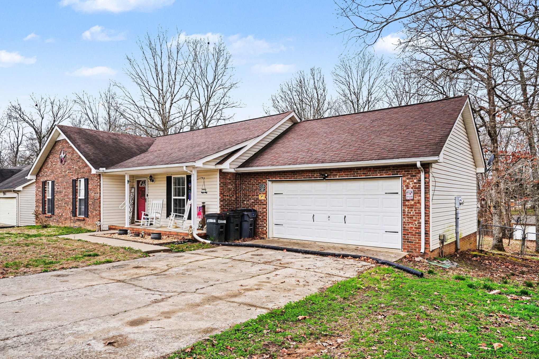 3475 Eastridge Road Woodlawn, TN 37191 - Photo 1 of 28 a front view of a house with a yard and garage