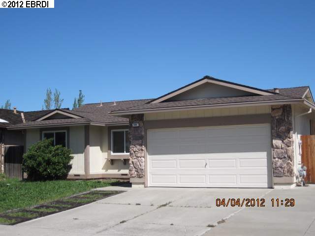 950 Rock Ridge Way Pittsburg, CA 94565 - Photo 1 of 1 a front view of a house with a garden and garage