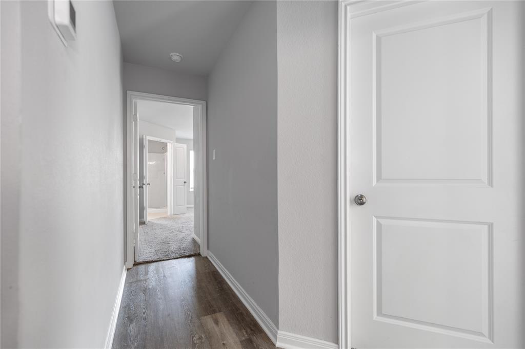 3933 Rimfire Road Waco, TX 76705 - Photo 11 of 27 a view of a hallway with wooden floor