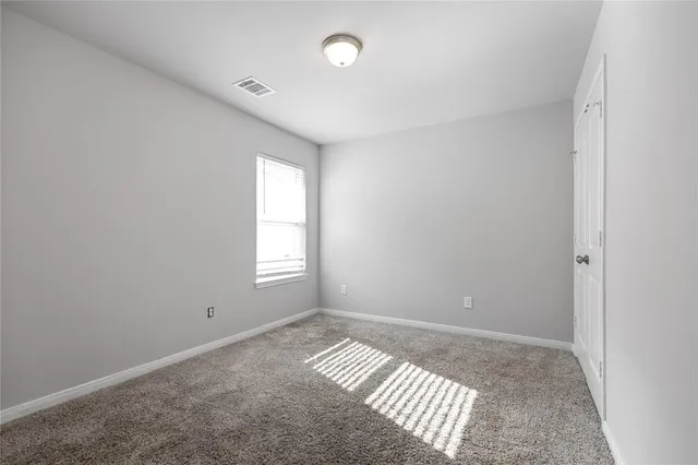 a view of an empty room and closet area