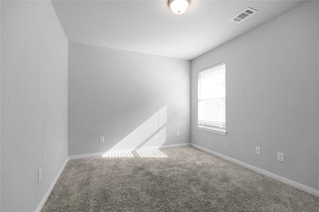 3933 Rimfire Road Waco, TX 76705 - Photo 15 of 27 an empty room with windows