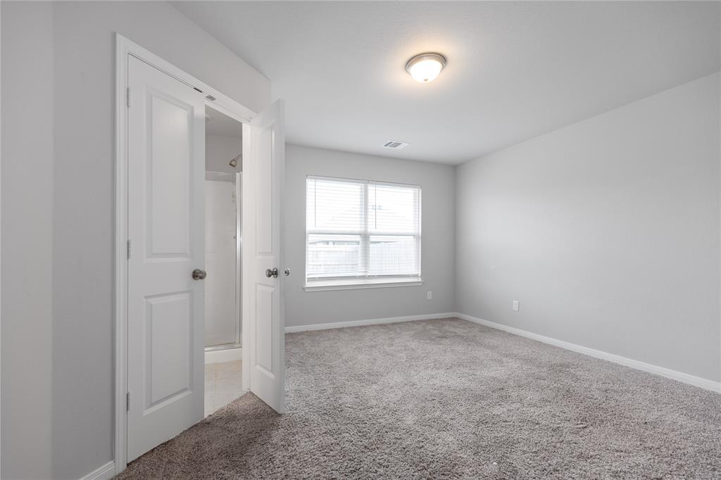 3933 Rimfire Road Waco, TX 76705 - Photo 17 of 27 a view of an empty room with a window