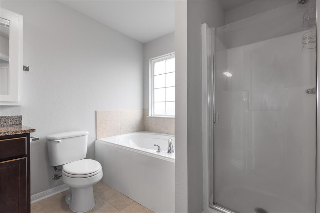 3933 Rimfire Road Waco, TX 76705 - Photo 19 of 27 a white toilet sitting next to a bathroom sink