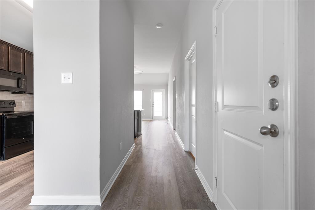3933 Rimfire Road Waco, TX 76705 - Photo 2 of 27 a view of a hallway with wooden floor