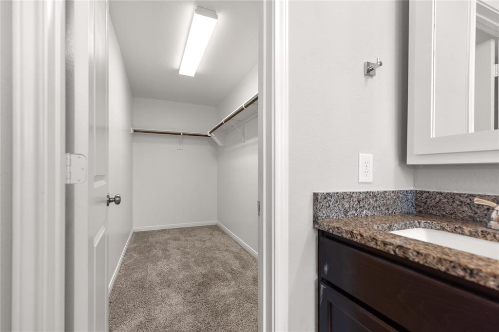 3933 Rimfire Road Waco, TX 76705 - Photo 21 of 27 a bathroom with a granite countertop sink and a granite
