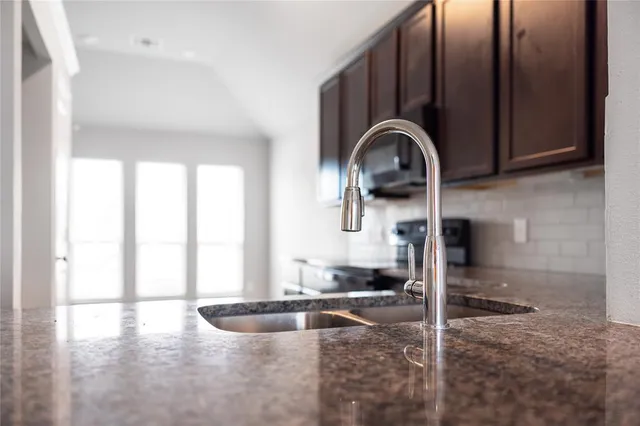 a front view of a house with a garden and yard