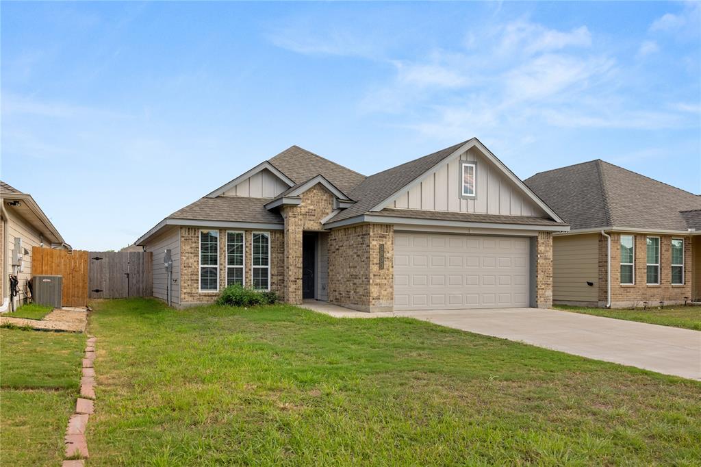 3933 Rimfire Road Waco, TX 76705 - Photo 24 of 27 a front view of a house with a garden and yard