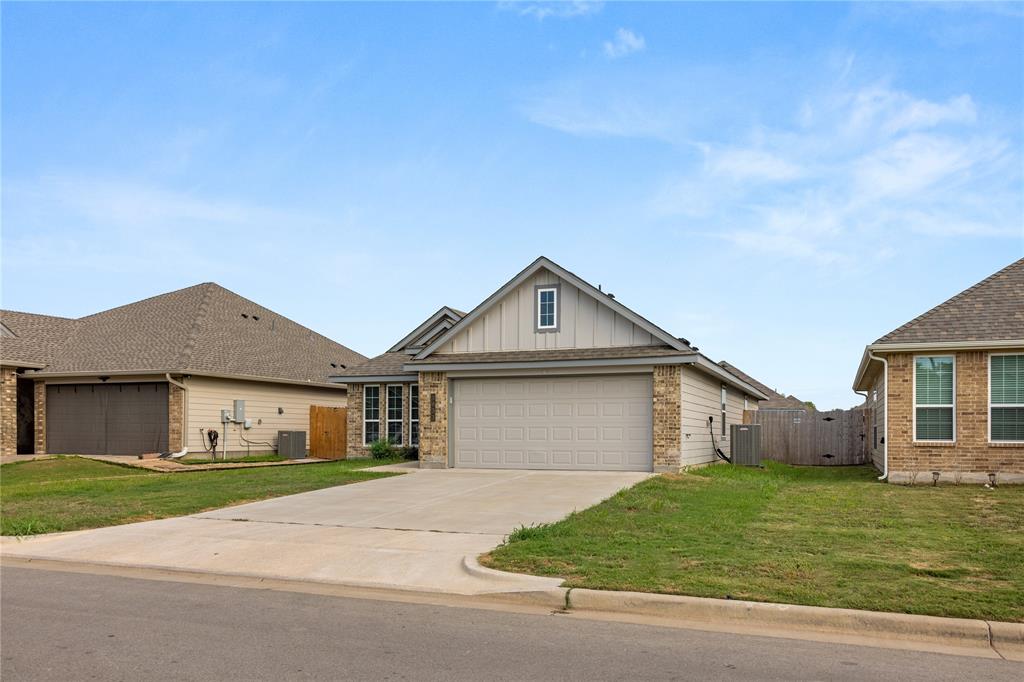 3933 Rimfire Road Waco, TX 76705 - Photo 25 of 27 a front view of a house with a garden and yard