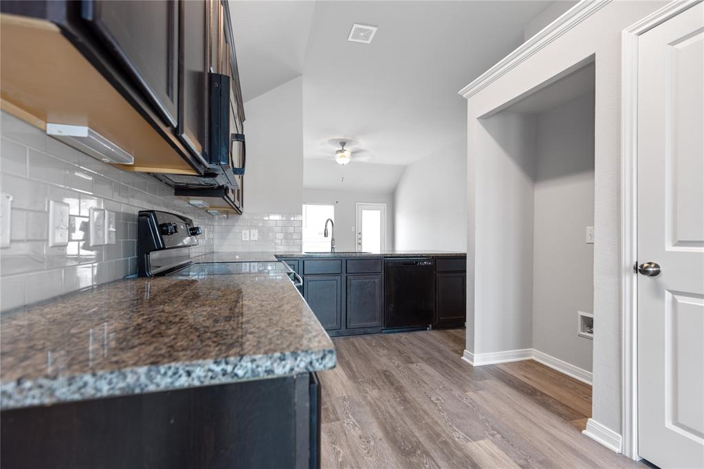 3933 Rimfire Road Waco, TX 76705 - Photo 4 of 27 a kitchen with granite countertop a counter space and cabinets
