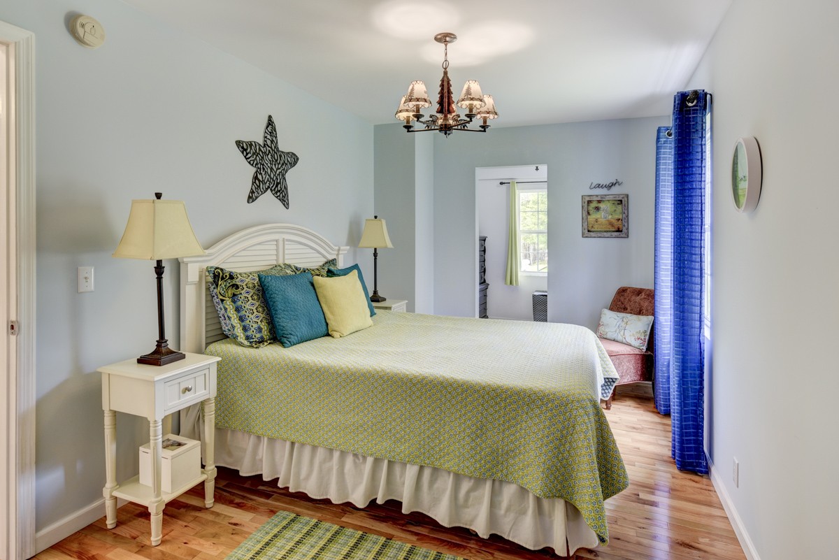 8565 South Tatum Creek Road Lyles, TN 37098 - Photo 15 of 31 a bedroom with a bed and wooden floor