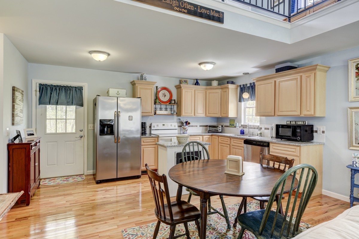 8565 South Tatum Creek Road Lyles, TN 37098 - Photo 24 of 31 a kitchen with stainless steel appliances granite countertop a dining table chairs refrigerator and cabinets