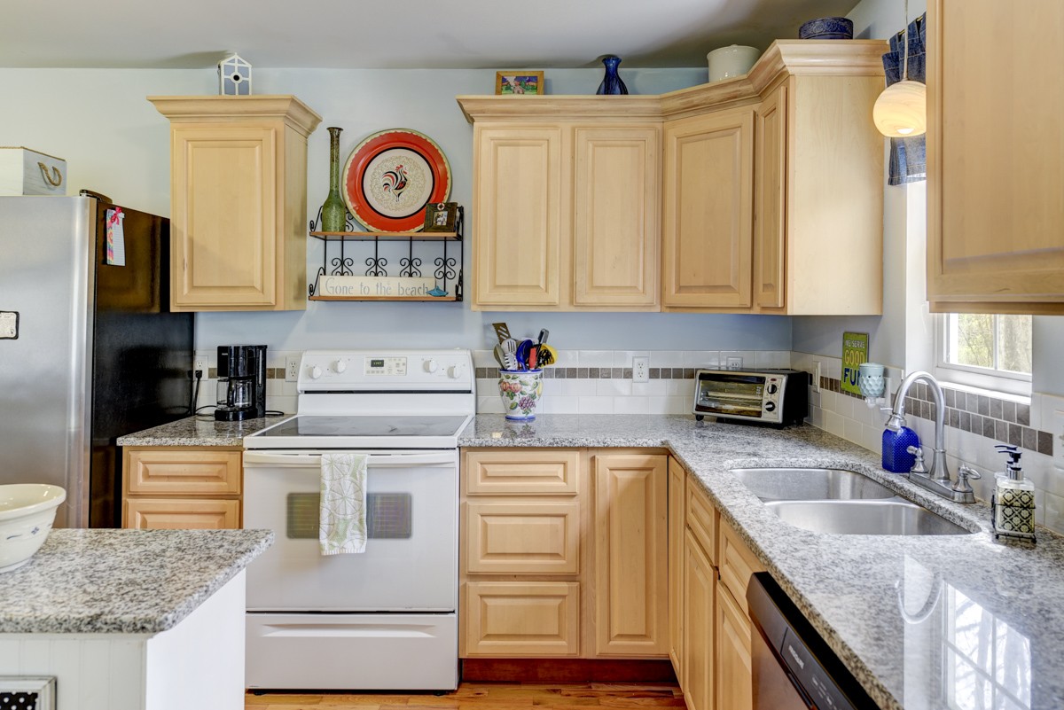 8565 South Tatum Creek Road Lyles, TN 37098 - Photo 26 of 31 a kitchen with granite countertop stainless steel appliances granite countertop a stove a sink and a microwave