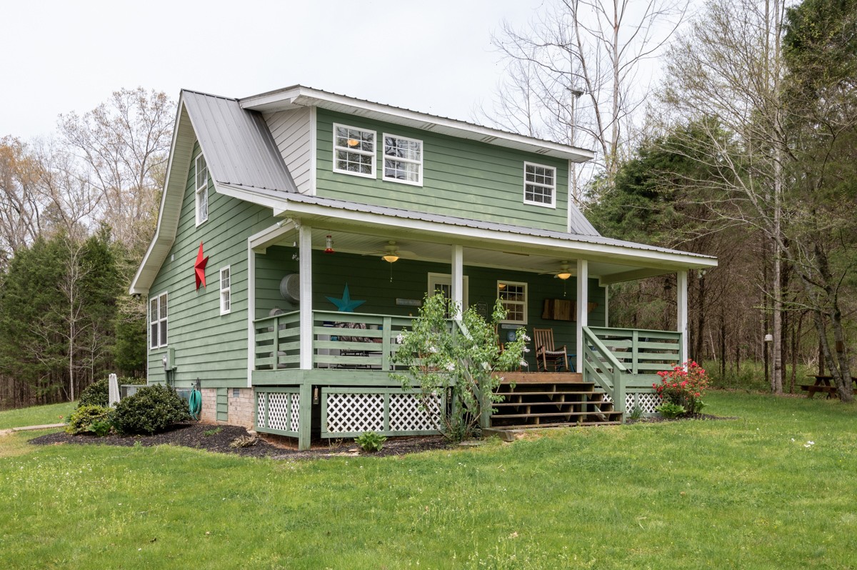 8565 South Tatum Creek Road Lyles, TN 37098 - Photo 6 of 31 a front view of a house with a yard
