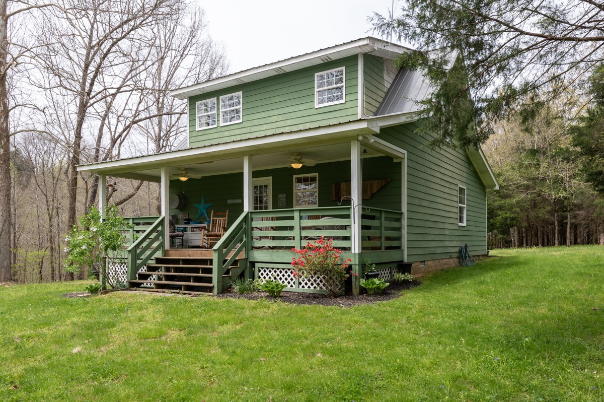 8565 South Tatum Creek Road Lyles, TN 37098 - Photo 9 of 31 a view of a house with a yard and plants