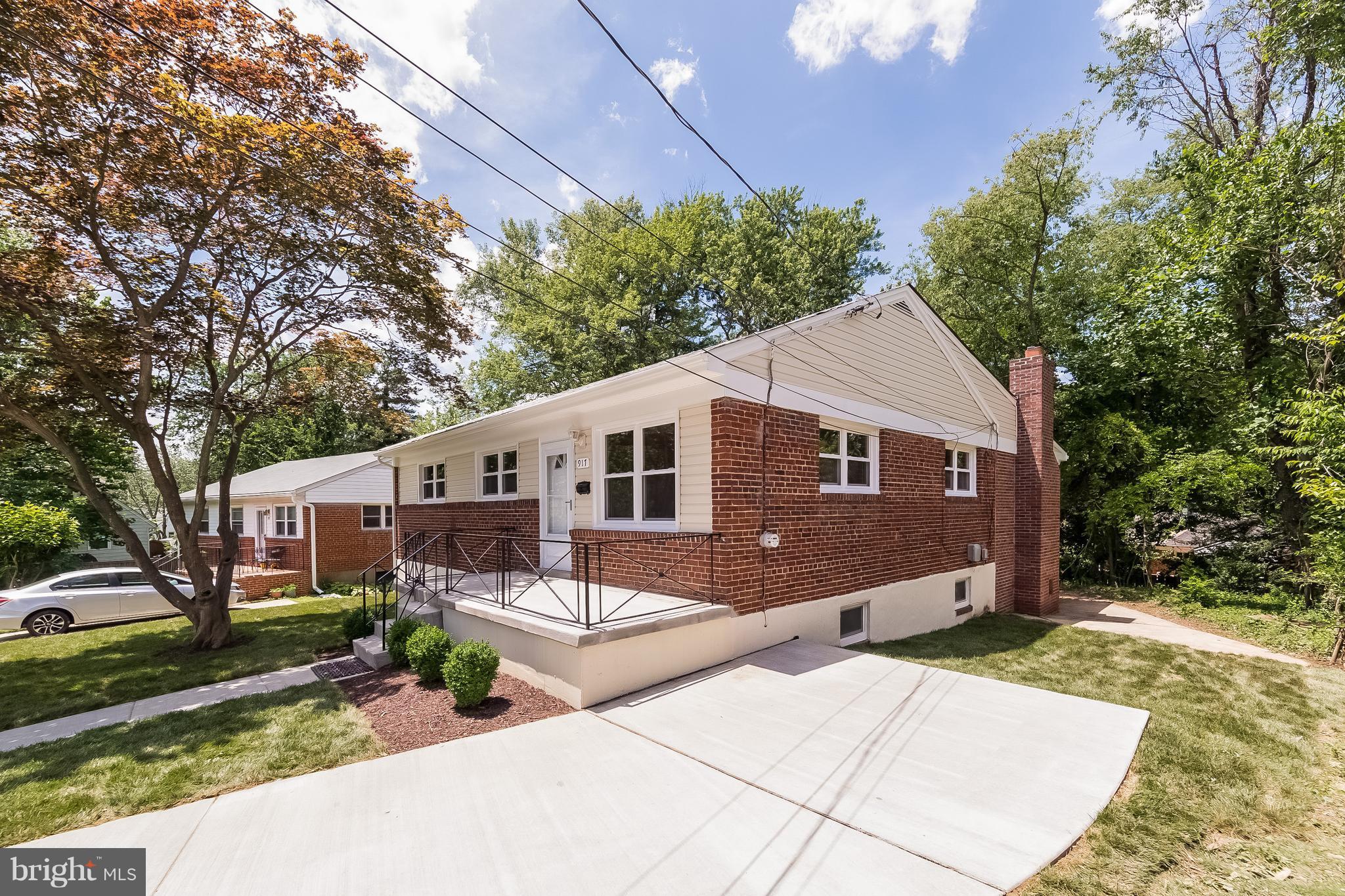 917 Benson Terrace Silver Spring, MD 20901 - Photo 2 of 25 a front view of a house with yard and trees in the background