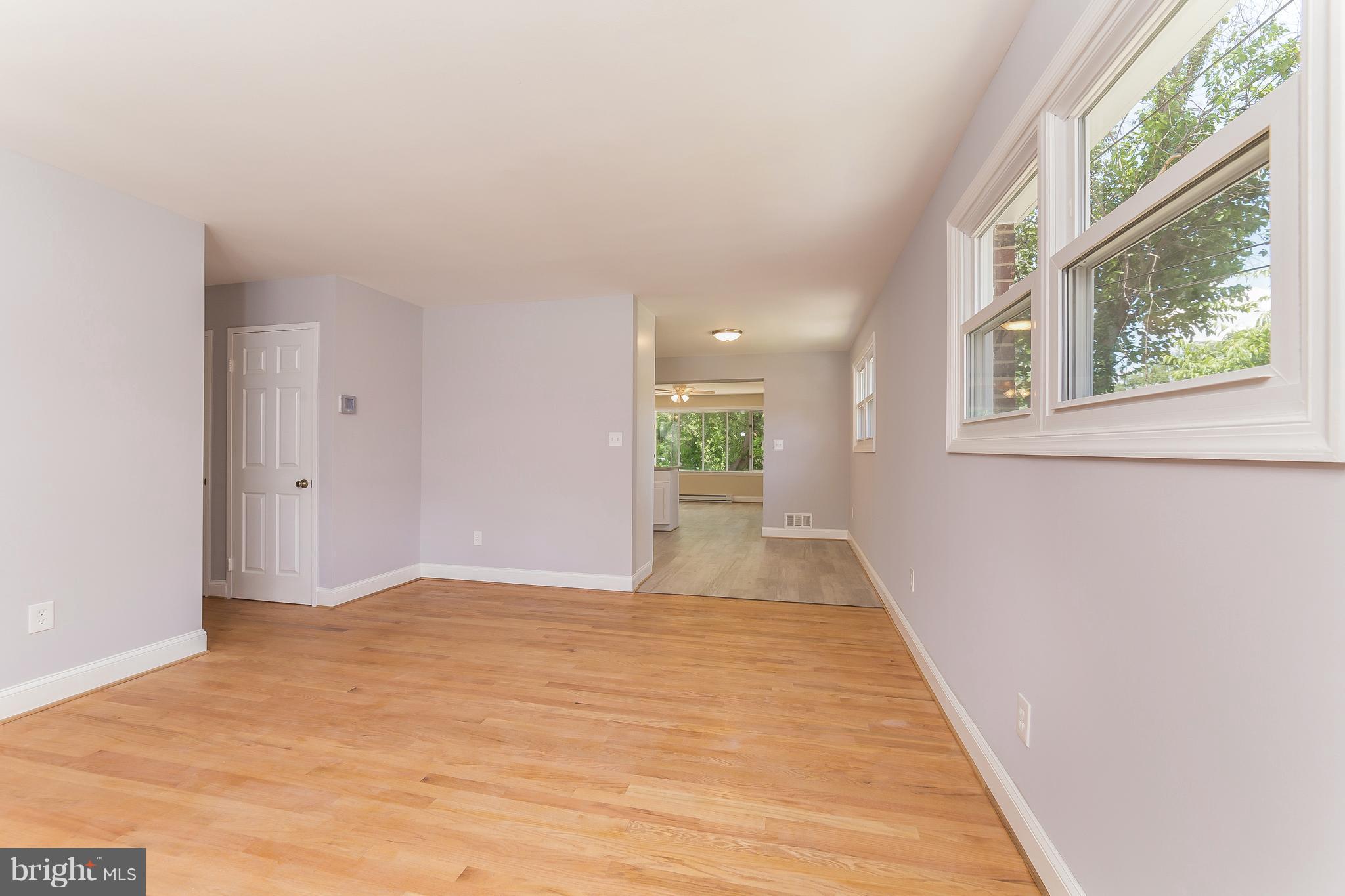 917 Benson Terrace Silver Spring, MD 20901 - Photo 4 of 25 a view of an empty room with wooden floor and a window