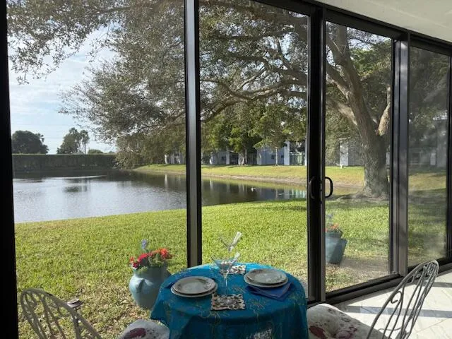 a living room with furniture and a floor to ceiling window
