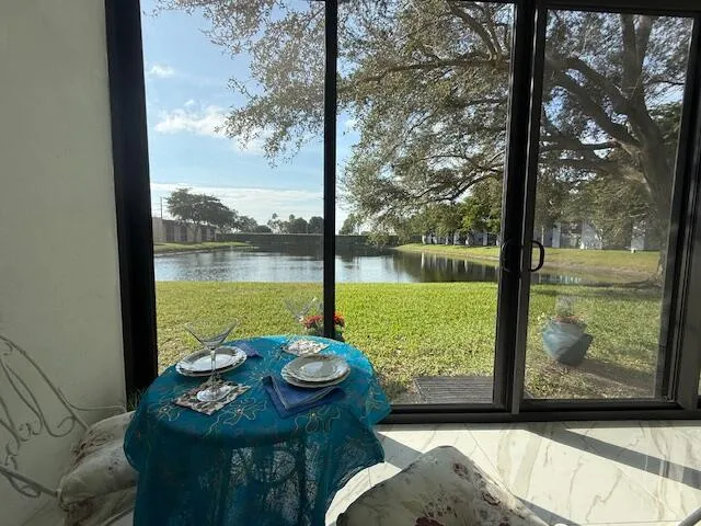 a view of a city from a dining room with a table & chairs