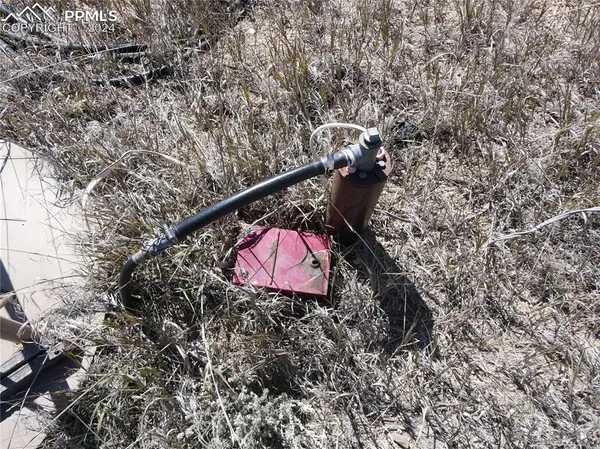 a view of a big building with wooden fence