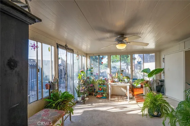 a building outdoor space with patio furniture and potted plants