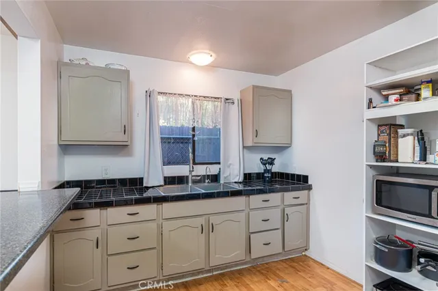 a spacious bathroom with a granite countertop sink and a mirror