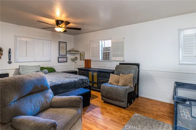 a bedroom with a bed couch and window