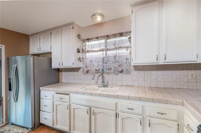 a kitchen with cabinets stainless steel appliances and a counter space