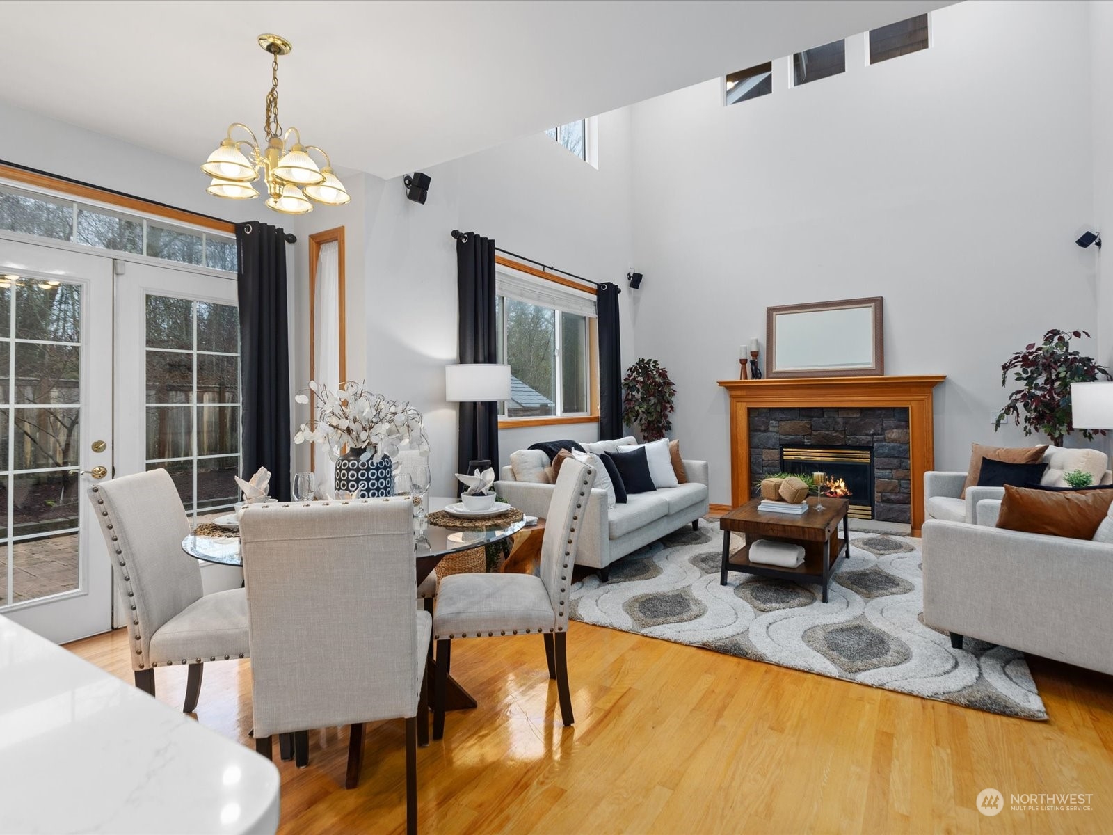 1010 185th Street Southeast Bothell, WA 98012 - Photo 7 of 16 a living room with furniture a chandelier and a fireplace
