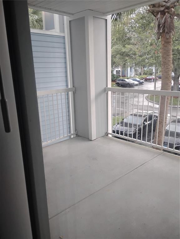 2549 Grassy Point Drive, Unit 203 Lake Mary, FL 32746 - Photo 18 of 22 a view of a porch with wooden floor and fence