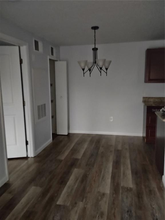 2549 Grassy Point Drive, Unit 203 Lake Mary, FL 32746 - Photo 7 of 22 a view of an empty room with wooden floor and a fireplace