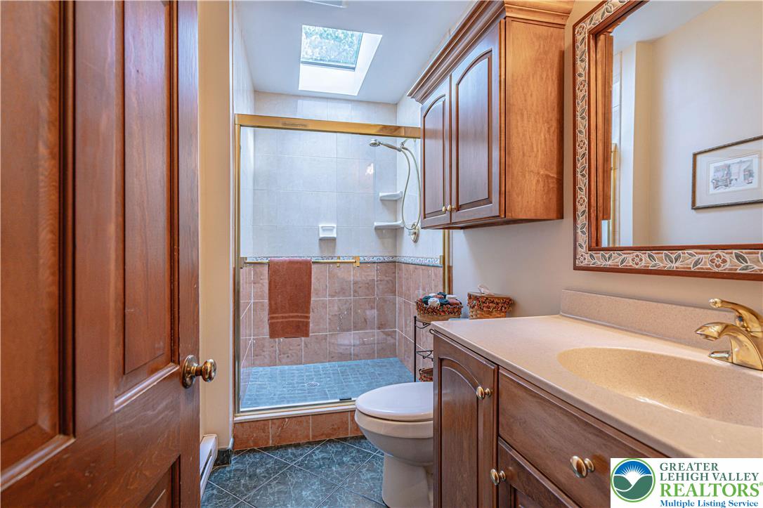 1434 Colgate Drive Bethlehem, PA 18017 - Photo 19 of 37 a bathroom with a sink a toilet and bathtub