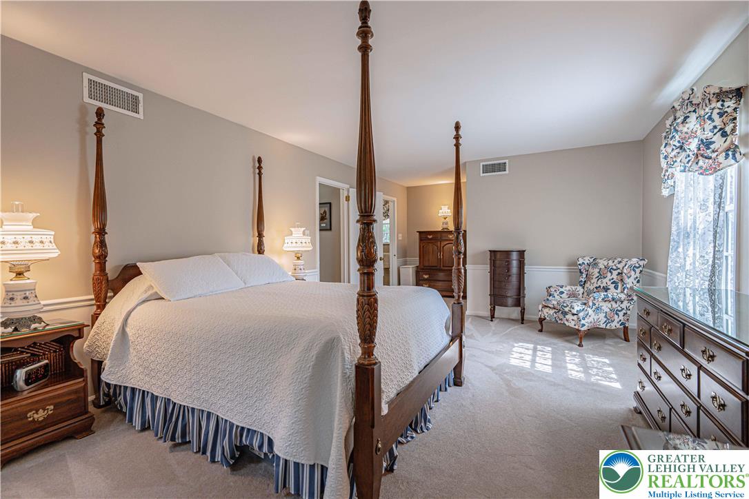 1434 Colgate Drive Bethlehem, PA 18017 - Photo 26 of 37 a bedroom with bed and a chandelier