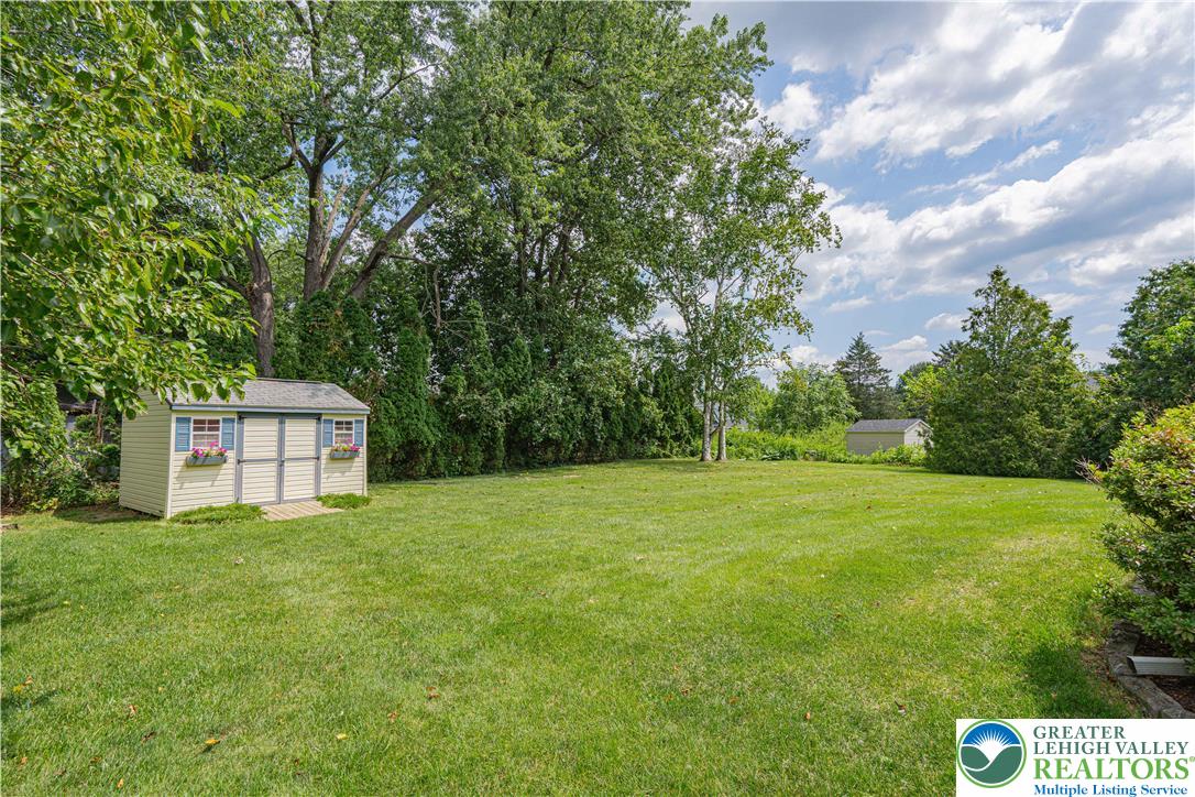 1434 Colgate Drive Bethlehem, PA 18017 - Photo 37 of 37 a backyard of a house with plants and large trees