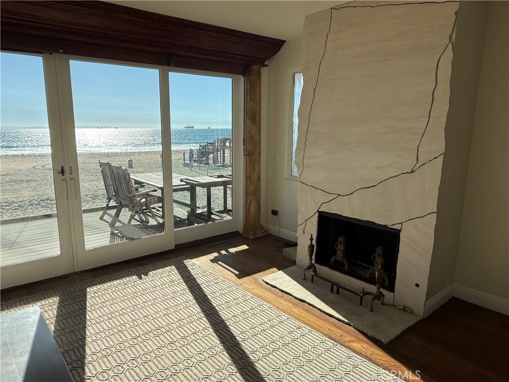87 A Surfside Avenue Surfside, CA 90743 - Photo 12 of 14 a living room with a flat tv screen and a fireplace