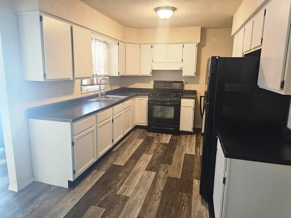 a kitchen with stainless steel appliances a refrigerator sink and cabinets