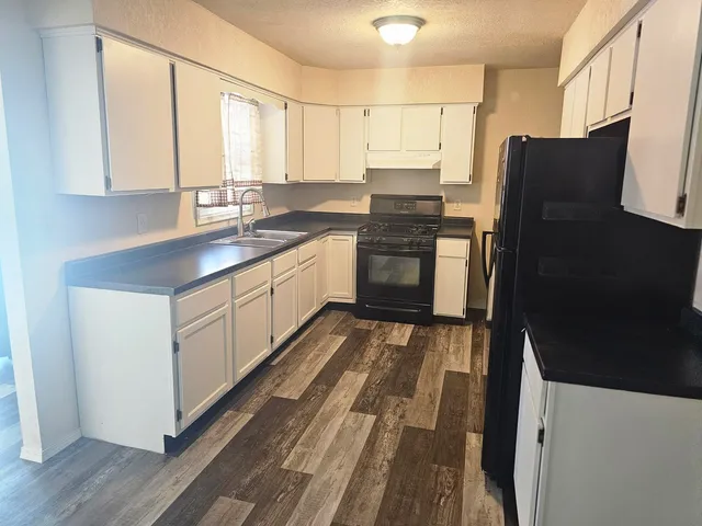a kitchen with stainless steel appliances a refrigerator sink and cabinets