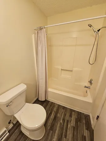 a bathroom with a toilet and a shower